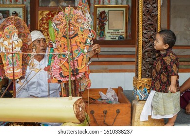 GIANYAR/BALI-AUGUST 14 2019: A Young Balinese Child Watching A Shadow Play. Wayang Kulit Or Shadow Puppets Is One Of Balinese Arts That Is Continuously Preserved