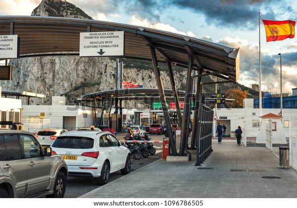 GIBRALTAR, EUROPE - DECEMBER 2017: Customs\
control point at Spanish border in LaLinea town. Rock of Gibraltar\
at background - British oversee\
territory
