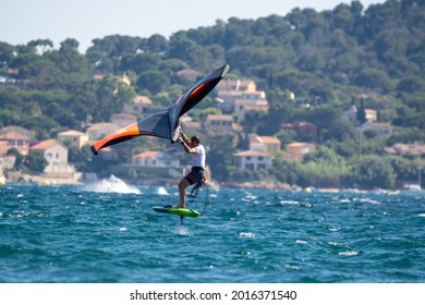 Giens, Almanarre beach, France 10 July 2021. Extreem water sports - wing foil, kite surfing, wind surfindg, windy day on Almanarre beach near Toulon, South of France