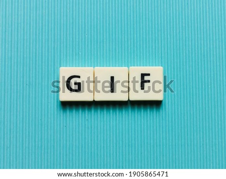 GIF word made from square letter tiles on turquoise background.