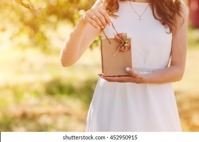 Gift Bag With A Bow In The Hands Of Women On A Wedding Anniversary