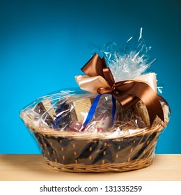 Gift In A Basket Against Blue Background