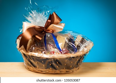 Gift In A Basket Against Blue Background