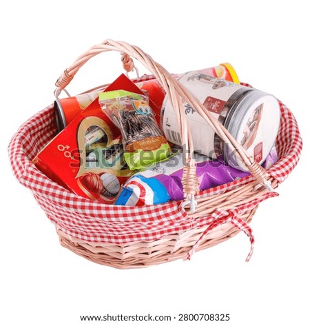 Gift basket filled with assorted snacks and packaged treats isolated on white background