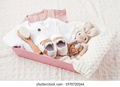 Gift basket with gender neutral baby garment and accessories. Care box of organic newborn cotton clothes - Powered by Shutterstock