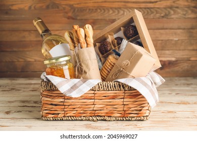 Gift basket with products on wooden background - Shutterstock ID 2045969027