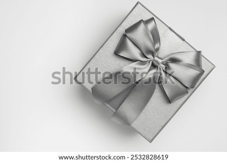 Gift box with bow on light grey background, top view. Space for text