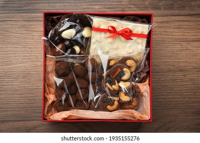 Gift Box With Chocolate And Sweets On Wooden Table, Top View