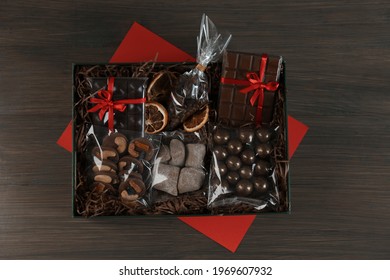 Gift Box With Chocolate And Sweets On Wooden Table, Top View