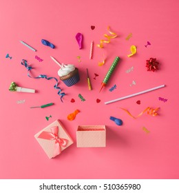 Gift Box With Colorful Party Items On Pink Background. Flat Lay.