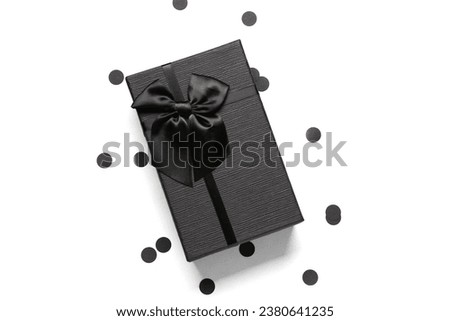Gift box and confetti on white background. Black Friday