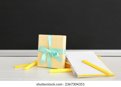 Gift box with different stationery on white wooden table in classroom - Powered by Shutterstock