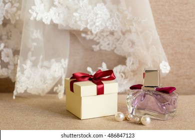 Gift Box, Earrings, Perfume, And The Veil Of The Bride Close-up