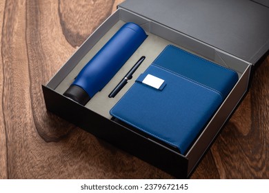 Gift box, an elegantly wrapped package, representing thoughtfulness, concealing surprises and thoughtful expressions of appreciation and love. It contains a notebook, flask, pen and much more.