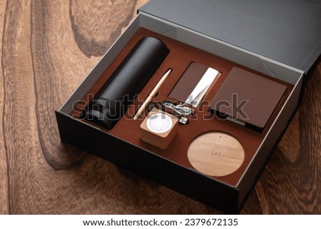 Gift box, an elegantly wrapped package, representing thoughtfulness, concealing surprises and thoughtful expressions of appreciation and love. It contains a notebook, flask, pen and much more.