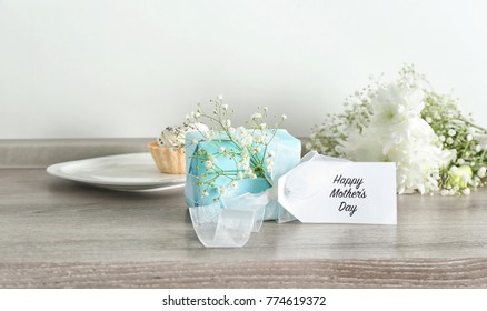 Gift Box With Flowers For Mother's Day On Table