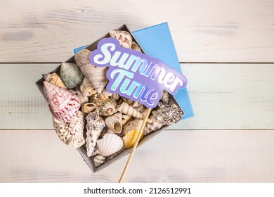 Gift Box Full Of Seashells, Stars And Summer Holiday Souvenirs From Sea On Light Wood Boards