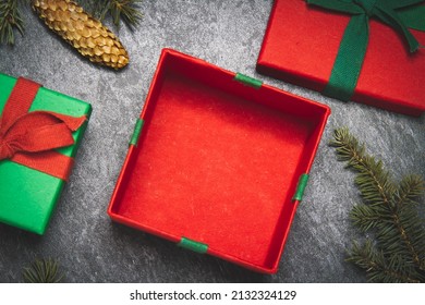 Gift box on a black background. New Year's gift top view. Red and green boxes. Surprise on the table.