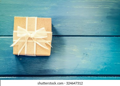 Gift box on blue wooden table,vintage filter
