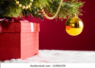 Gift Box On Snow Under Christmas Tree