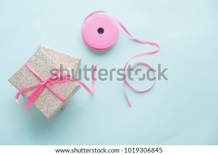 Gift box with pink satin bow.