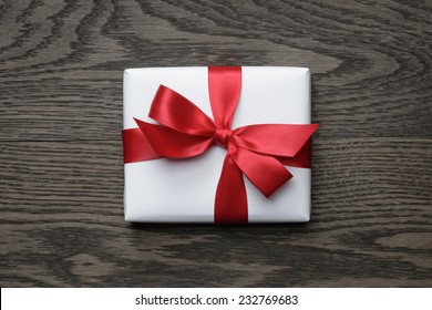 Gift Box With Red Bow On Wood Table, Top View