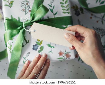 Gift box wrapped with floral patterned paper with a card mockup