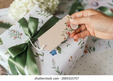 Gift box wrapped with floral patterned paper with a card mockup