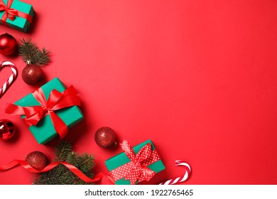 Gift boxes and Christmas decorations on red background, flat lay. Space for text - Powered by Shutterstock