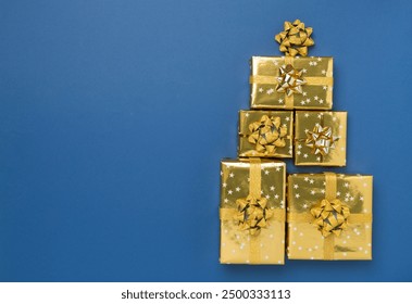 Gift boxes in Christmas tree shape on color background, top view - Powered by Shutterstock