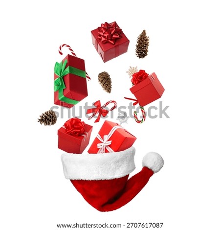 Gift boxes falling into Santa hat on white background