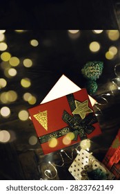 Gift boxes with a large red bow  against a background bokeh of twinkling party lights. Luxury New Year gift. Christmas gift. Christmas background with gift box. Christmastime celebration