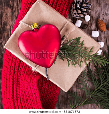 Gift, fir branch, nuts, cones, cozy knitted blanket. Winter, New Year, Christmas still life.