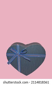 Gift For Him. A Blue Heart-shaped Box With A Bow On A Pink Background As An Illustration For Valentine's Day.