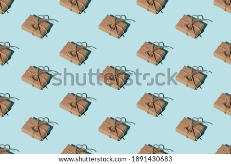 Gift pattern. Blue seamless background. Vintage mail parcel. Holiday congratulation creative design. Symmetrical composition of rustic beige handmade paper boxes with twine isolated on light.
