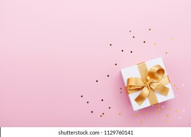 Gift Or Present Box And Stars Confetti On Pink Table Top View. Flat Lay Composition For Birthday, Mother Day Or Wedding.