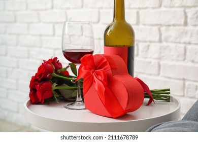 Gift For Valentine's Day, Flowers And Wine On Table