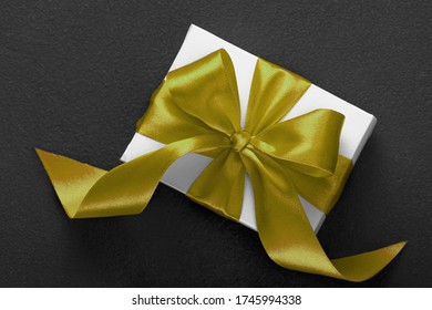 Gift white box with a red bow on a dark background. Valentine's Day, Christmas, Birthday, Mother's Day. - Shutterstock ID 1745994338