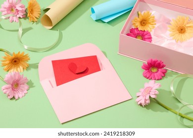 Gift wrap, ribbons, cards, fresh flowers, and a box on pastel green background. Capturing the essence of homemade gifts in a delightful close-up composition. - Powered by Shutterstock