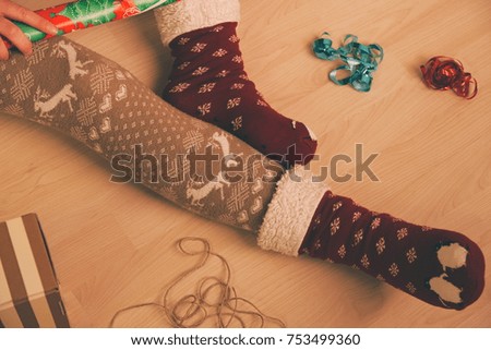 Gift Wrapping and Christmas Preparations in Red Socks Closeup