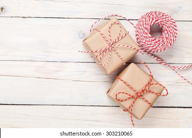 Gift wrapping over white wooden table with copy space