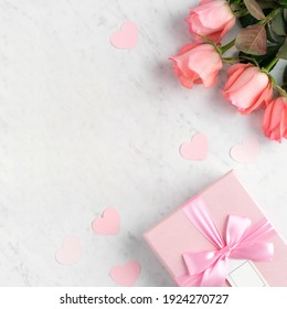 Giftbox And Pink Rose Flower On Marble White Table Background For Mother's Day Holiday Greeting Design Concept.