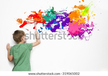 Gifted child drawing an abstract picture with colorful splatters
