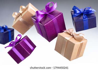Gifts in boxes, in bright festive packaging for various events. Gray background, studio shot.
