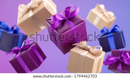 Gifts in flying boxes, wrapped in blue, purple and kraft paper with bow on lilac background. Sale, discounts.