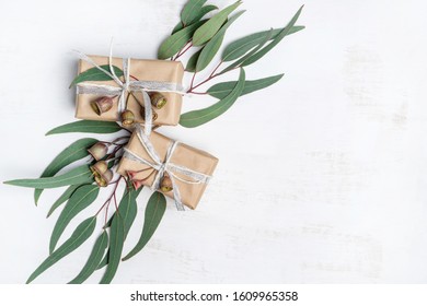 Gifts Surrounded By Australian Native Eucalyptus Leaves  Gum Nuts. Presents Are Wrapped In Natural Paper With Silver Ribbon  Twine. Christmas, Birthday, Valentines Day, Anniversary Or Mothers Day.