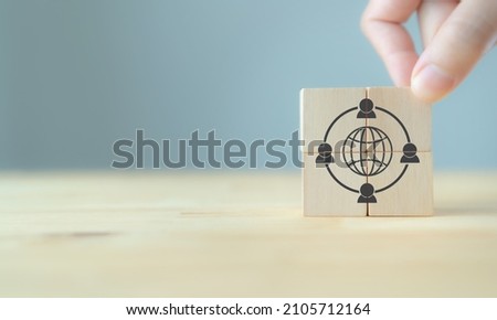 Gig economy, freelance, hybrid workplace concept. The combination of employment trend; growing to external hiring. Businessman puts wooden cubes with gig economy icon on grey background, copy space.