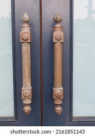 Gigantic Elaborate Fancy Decorated Brass Oriental Door Handles On A Blue Door Way.         