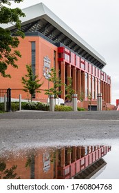 Gigantic new Main stand of Anfield stadium (home of Liverpool FC) seen in England in June 2020 reflecting in a puddle of water.