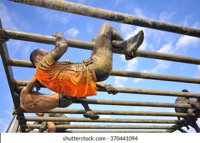 GIJON, SPAIN - JANUARY 31: Farinato Race, extreme obstacle race in January 31, 2016 in Gijon, Spain. People jumping, crawling,passing under a barbed wires obstacles during extreme obstacle race.
